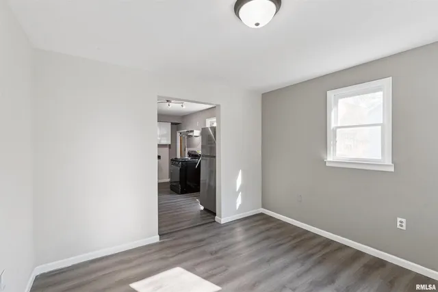 a view of a room with wooden floor and bathroom