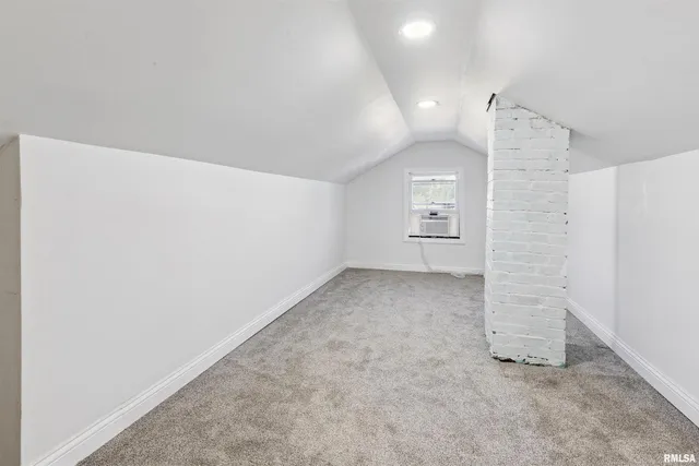 an empty room with a empty space and windows