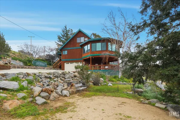 a view of a balcony with wooden floor and fence