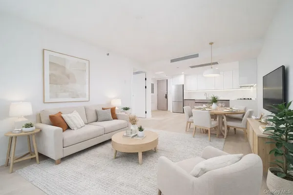 a living room with furniture a rug and a flat screen tv