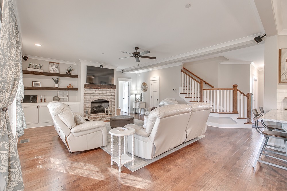 9630 Mona Road Murfreesboro, TN 37129 - Photo 2 of 39 a living room with furniture a fireplace and a chandelier