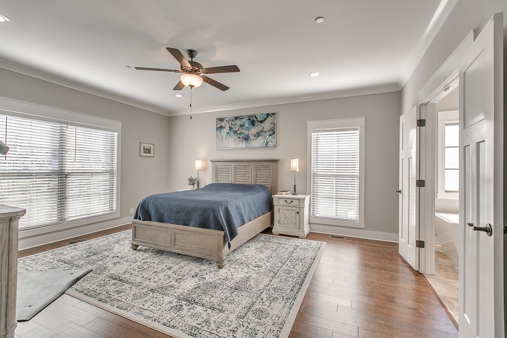 9630 Mona Road Murfreesboro, TN 37129 - Photo 11 of 39 a spacious bedroom with a large bed a chandelier and windows