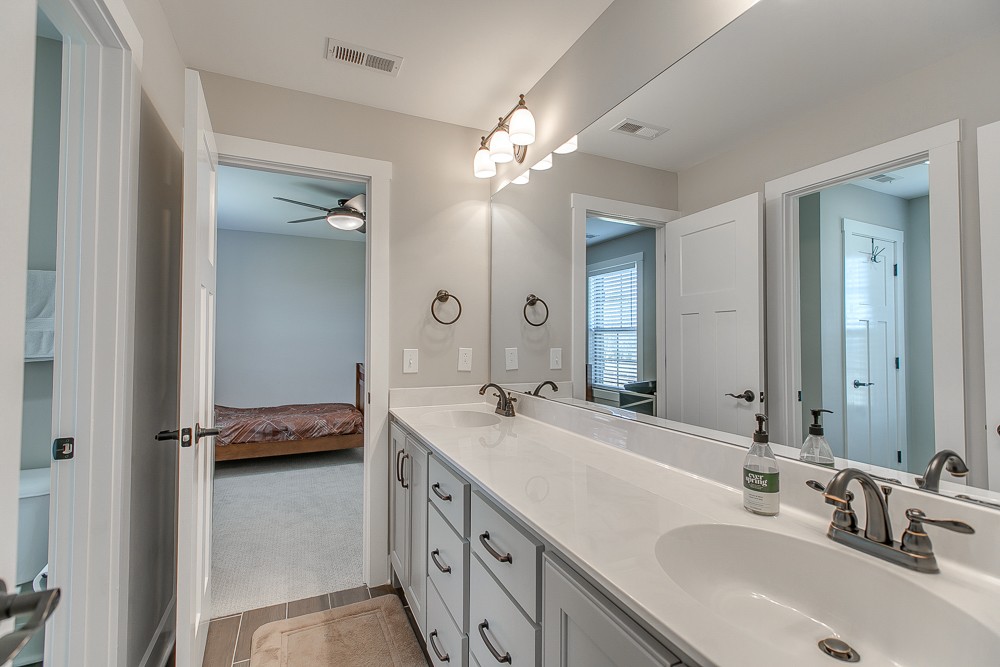 9630 Mona Road Murfreesboro, TN 37129 - Photo 25 of 39 a bathroom with a double vanity sink and a mirror
