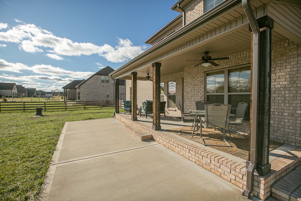 9630 Mona Road Murfreesboro, TN 37129 - Photo 34 of 39 a view of a patio with table and chairs with wooden floor and fence
