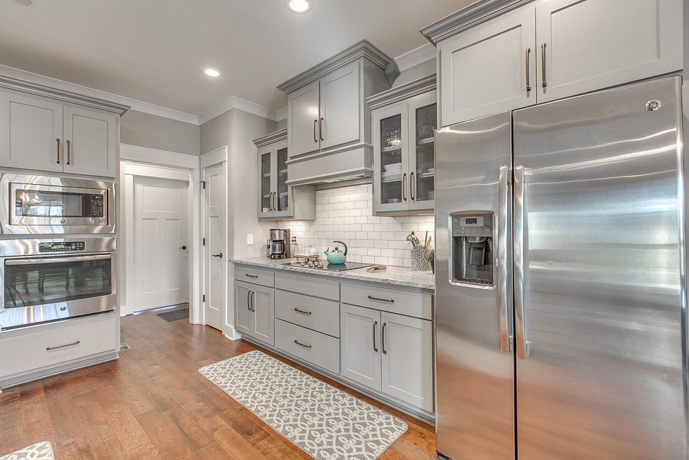 9630 Mona Road Murfreesboro, TN 37129 - Photo 7 of 39 a kitchen with stainless steel appliances kitchen island granite countertop a refrigerator a sink and white cabinets