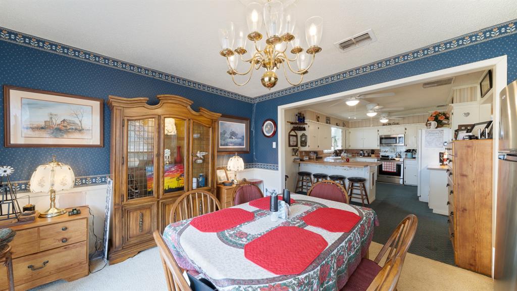 460 VZ County Road Canton, TX 75103 - Photo 13 of 24 a view of a dining room with furniture a chandelier and wooden floor