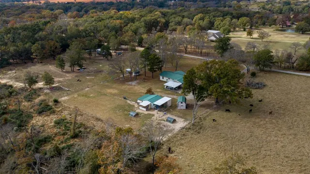a backyard of a house with a yard and outdoor seating