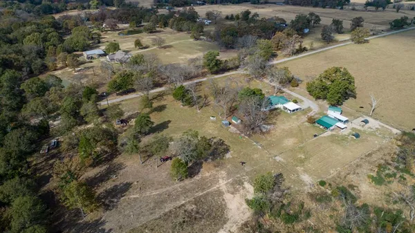 an aerial view of a house with a yard