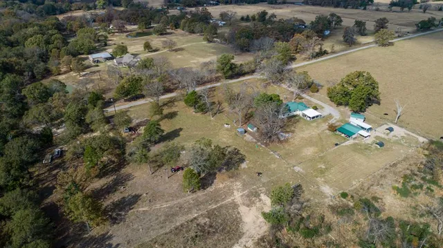 an aerial view of a house with a yard