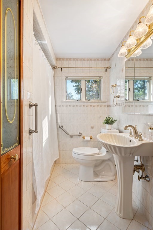 16 Westwood Road Lexington, MA 02420 - Photo 25 of 41 a bathroom with a sink a toilet and a mirror