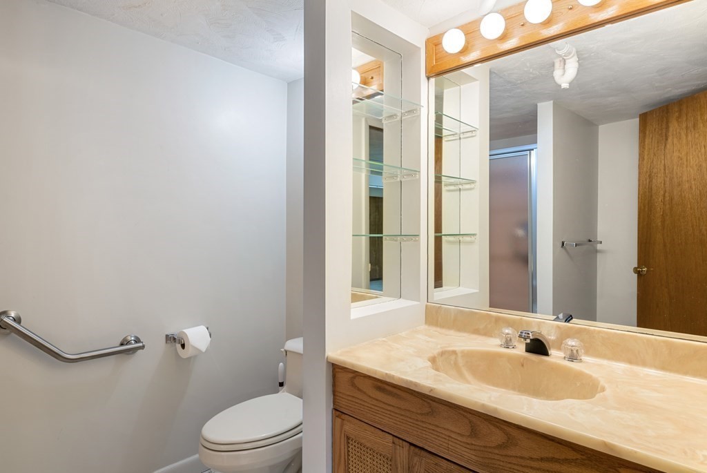 16 Westwood Road Lexington, MA 02420 - Photo 33 of 41 a bathroom with a granite countertop sink a toilet and shower