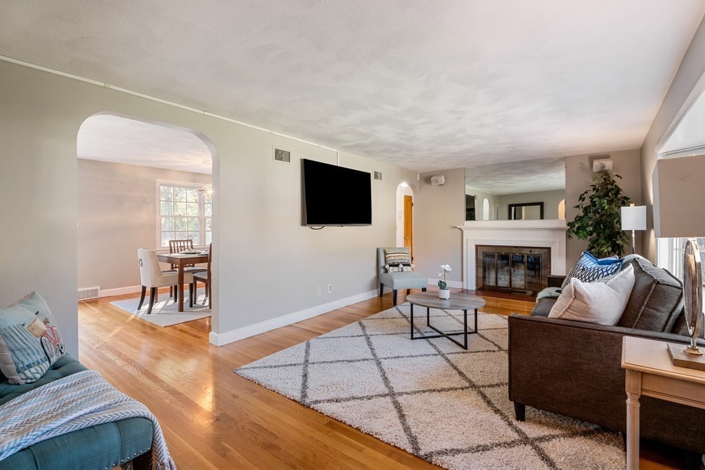 16 Westwood Road Lexington, MA 02420 - Photo 6 of 41 a living room with furniture a flat screen tv and a fireplace