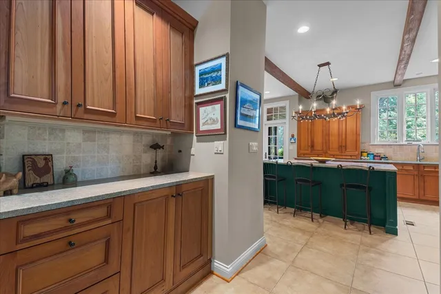 a kitchen with granite countertop wooden cabinets and white appliances