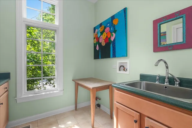 a bathroom with a sink a mirror and a window