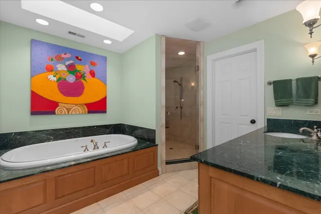 a bathroom with a sink a large mirror and a bathtub