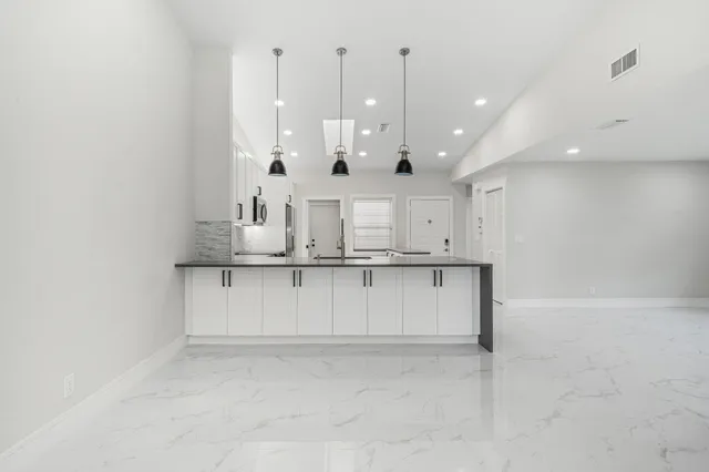 a view of kitchen and kitchen with stainless steel appliances