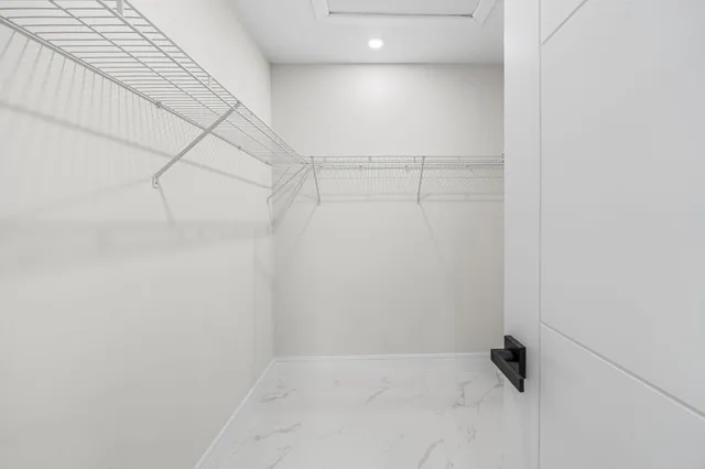 a bedroom with a bed a couch and a window