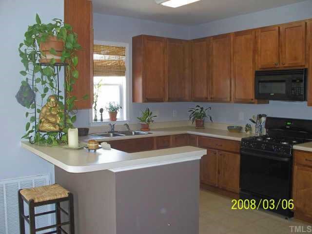 217 Cooke Street Raleigh, NC 27601 - Photo 3 of 12 a kitchen with a sink and cabinets