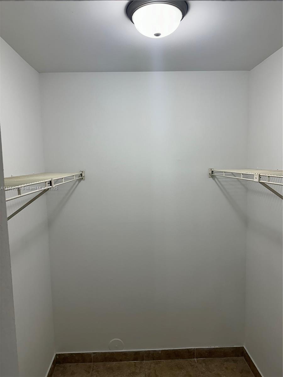 8100 Geneva Court, Unit 142 Doral, FL 33166 - Photo 2 of 11 a view of a room with racks on the wall