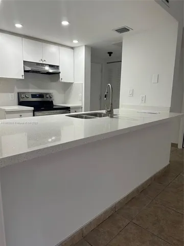 a view of a bathroom with a sink and mirror