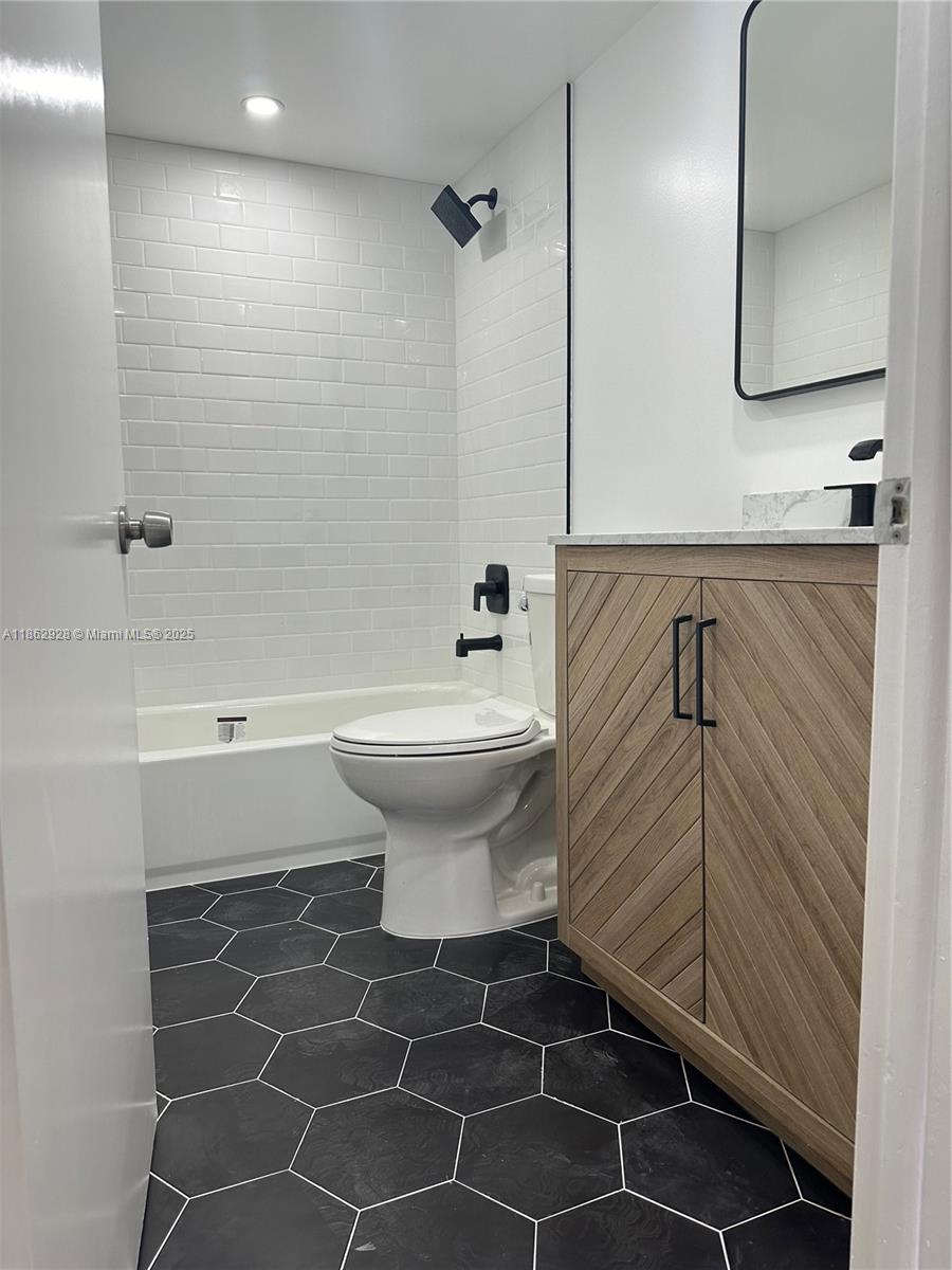 8100 Geneva Court, Unit 142 Doral, FL 33166 - Photo 6 of 11 a bathroom with a sink toilet and shower