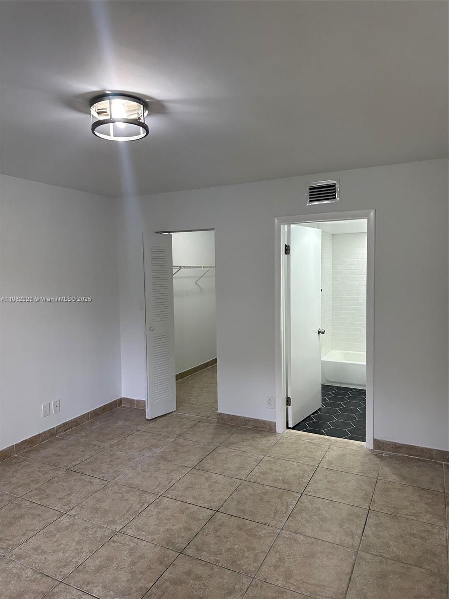 8100 Geneva Court, Unit 142 Doral, FL 33166 - Photo 9 of 11 an empty room with a bathroom