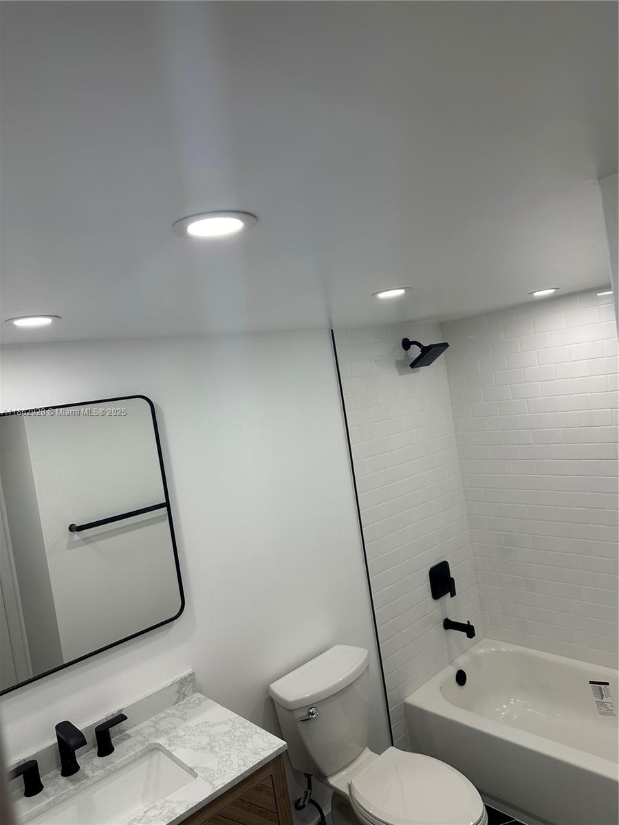 8100 Geneva Court, Unit 142 Doral, FL 33166 - Photo 10 of 11 a bathroom with a sink mirror vanity and toilet