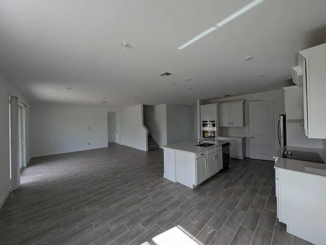 a kitchen with a refrigerator and a sink