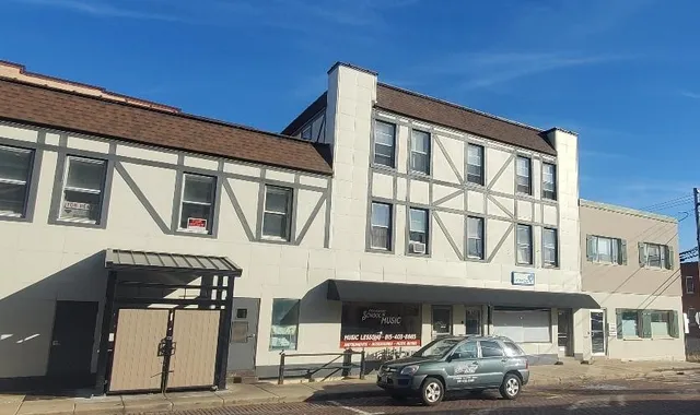 a front view of a building with parking space