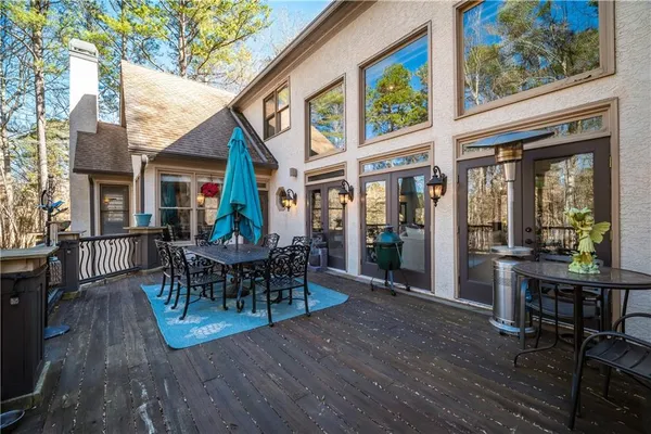 a view of a dinning table and chairs in patio of the house