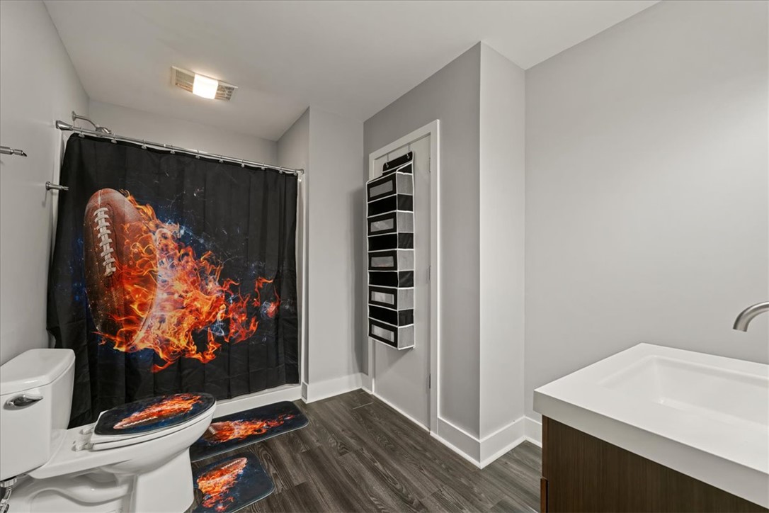 212 Winding Lane Seneca, SC 29672 - Photo 25 of 47 This sleek bathroom features contemporary flooring and a minimalist vanity, creating a refreshing atmosphere.