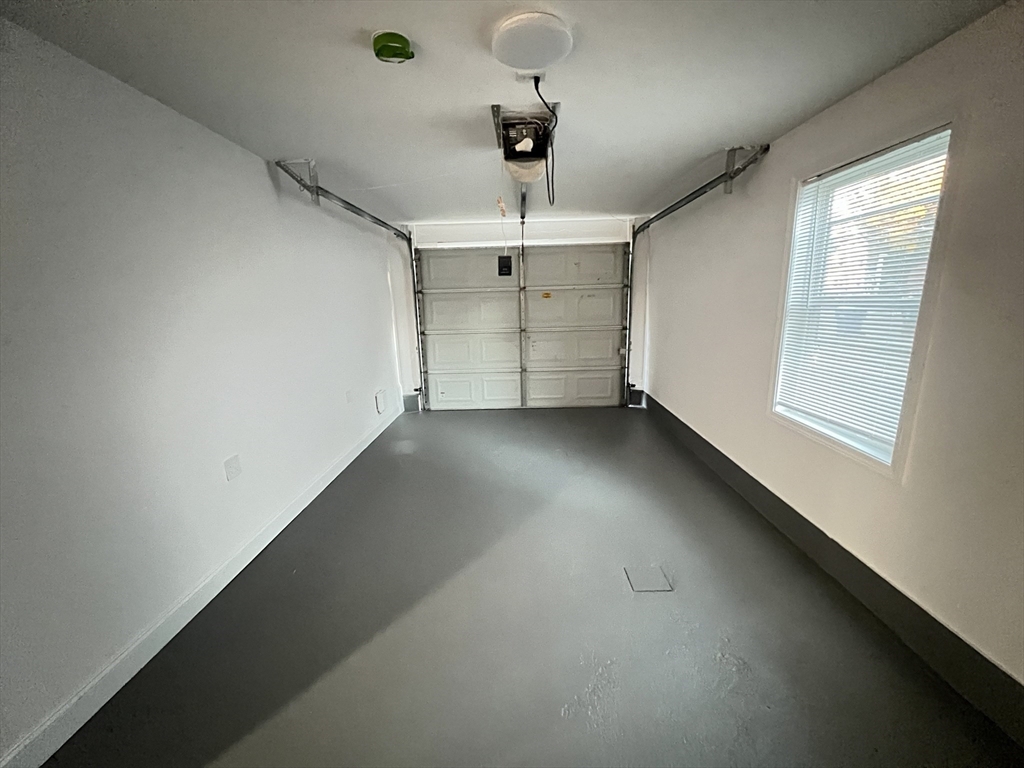 50 Conant Street, Unit 50 Danvers, MA 01923 - Photo 16 of 16 an empty room with chandelier fan and windows