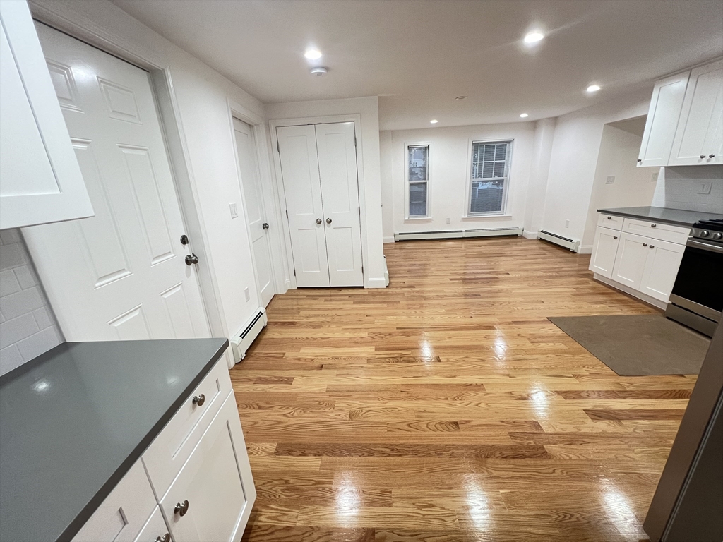 50 Conant Street, Unit 50 Danvers, MA 01923 - Photo 7 of 16 a view of an empty room with wooden floor and staircase