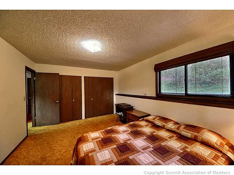 698 Deer Path Road Dillon, CO 80435 - Photo 14 of 25 a bedroom with a bed and a large window
