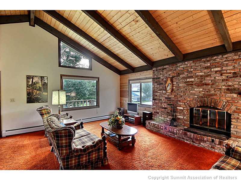 698 Deer Path Road Dillon, CO 80435 - Photo 3 of 25 a living room with furniture a flat screen tv and a fireplace