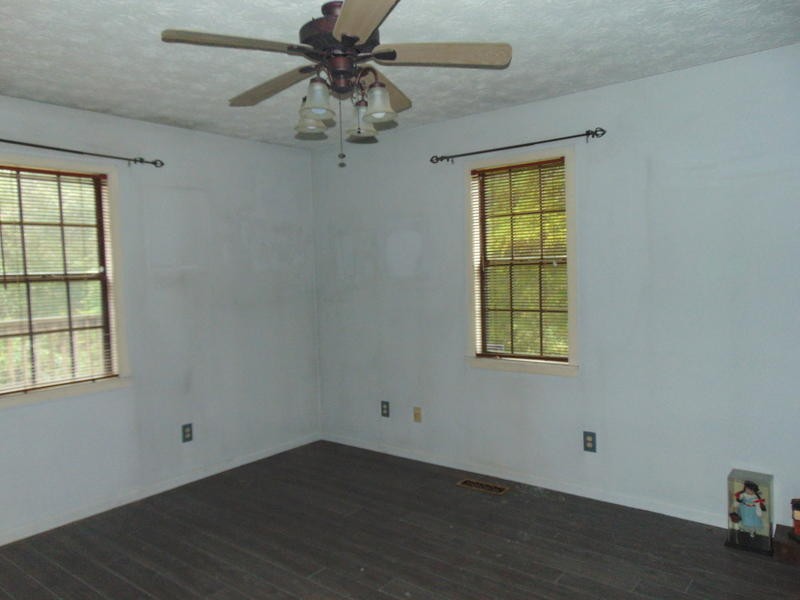 985 Rome Road Lancing, TN 37770 - Photo 7 of 11 an empty room with a window and a fan