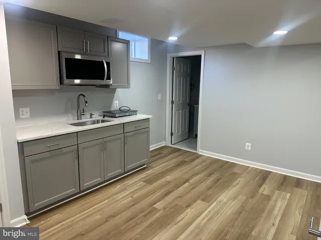a kitchen with a sink and a microwave