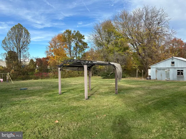 a backyard of apartments with large trees