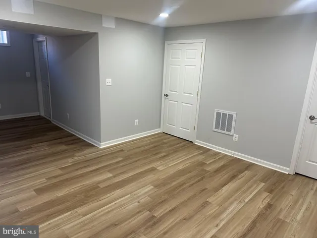 a view of a room with wooden floor