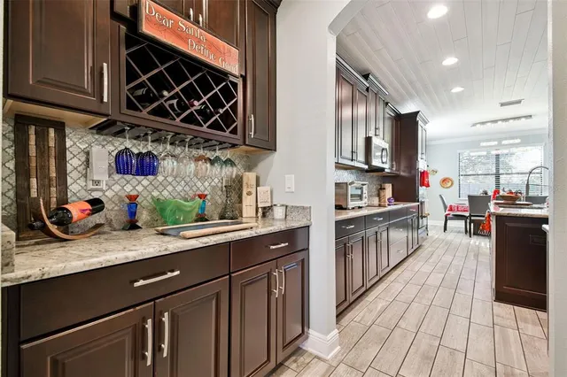 a kitchen with stainless steel appliances granite countertop a sink stove and cabinets