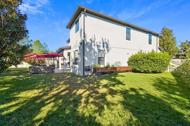 an aerial view of a house with a swimming pool patio and outdoor seating