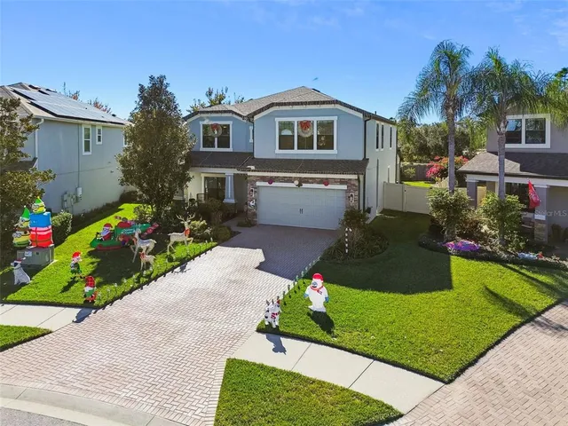 an aerial view of a swimming pool with a yard