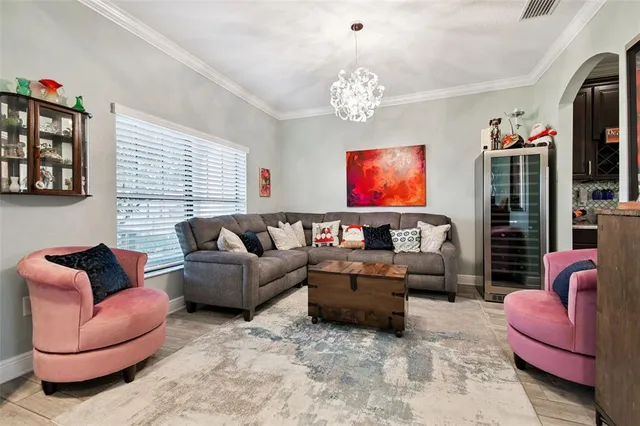 a living room with furniture or couch and a chandelier