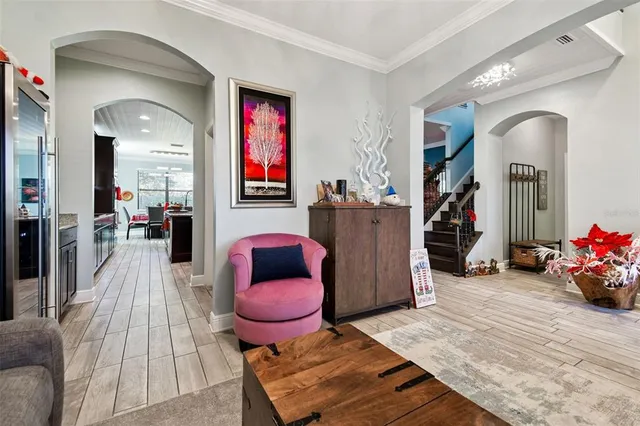a living room with furniture a flat screen tv and a mirror