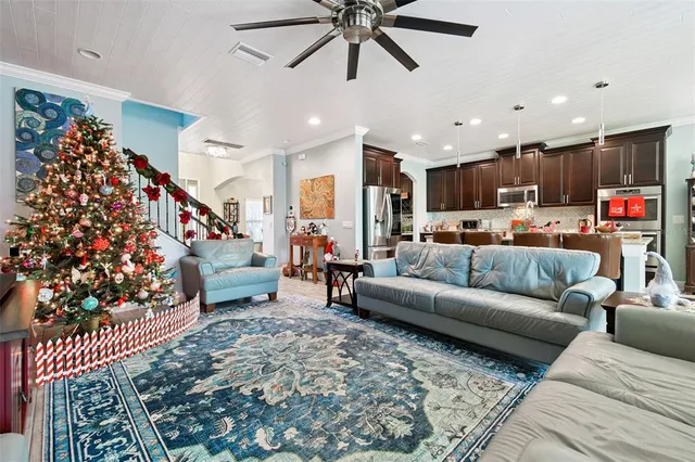 a living room with furniture and a chandelier
