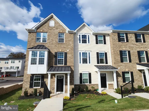 a front view of a residential apartment building with a yard