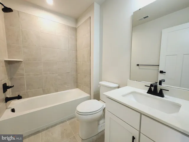a bathroom with a sink a toilet and a bathtub