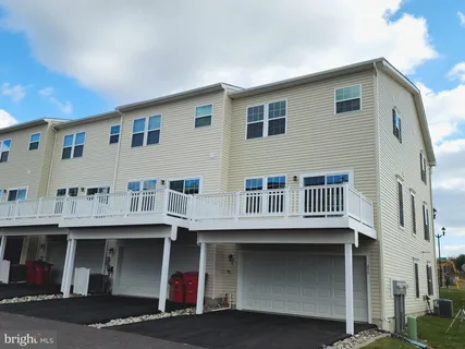 a view of a house with a garage and balcony