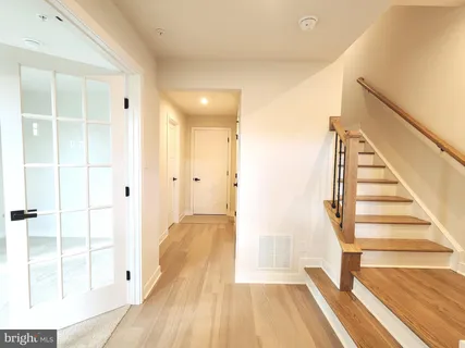 a view of a room with wooden floor and windows