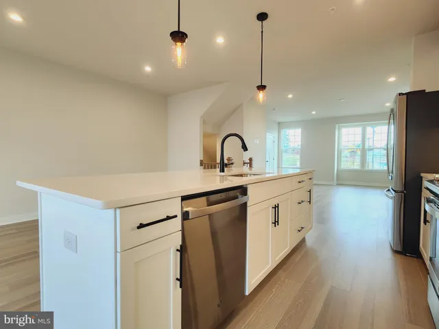 a kitchen with kitchen island a sink and a stove top oven